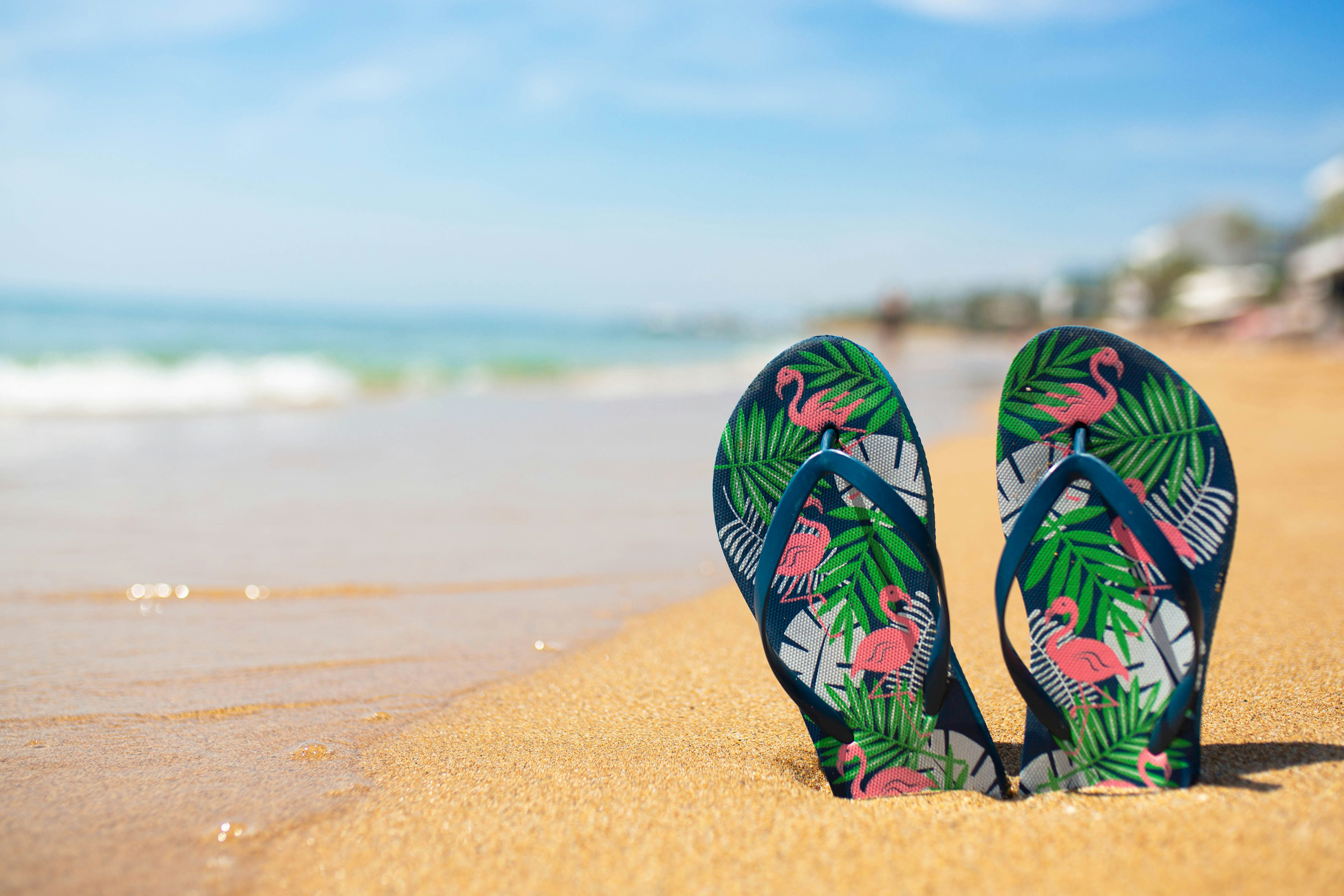 Stylish beach sandals with ocean backdrop