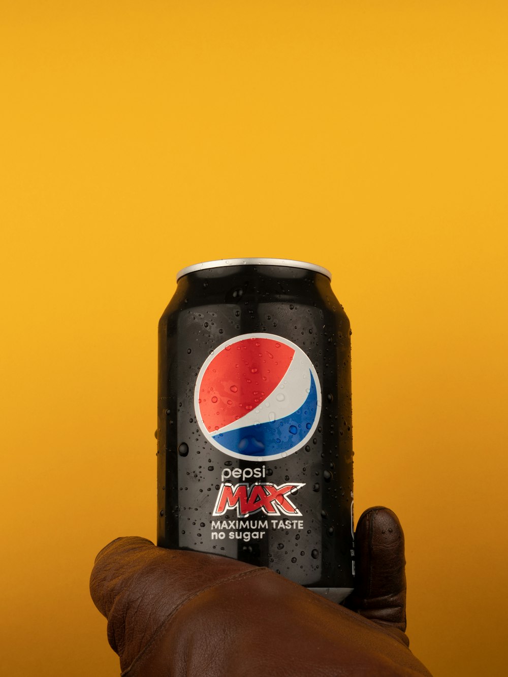 a hand holding a black can