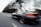 A dynamic shot of a custom-built car on an open road.