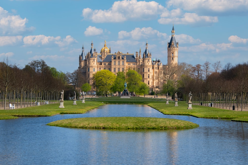 a castle with a pond in front of it with Schwerin Palace in the background