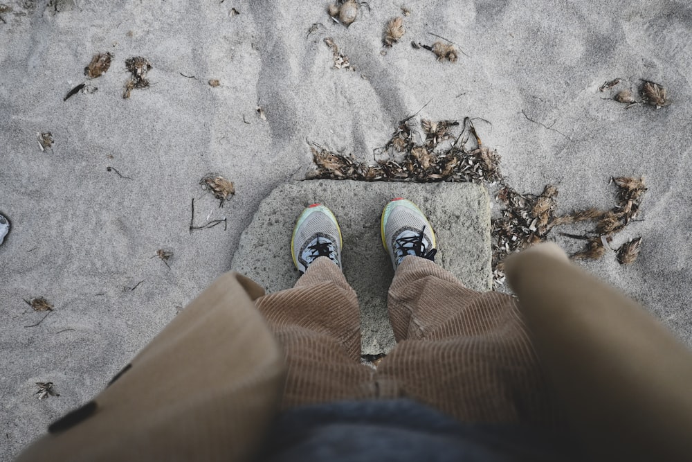 a pair of feet on a sandy beach