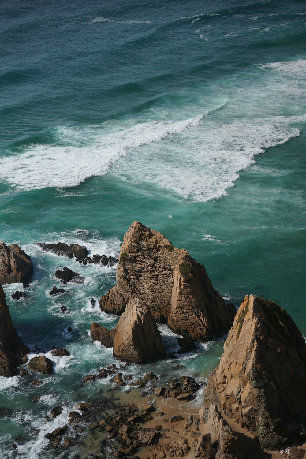 a rocky beach with waves crashing