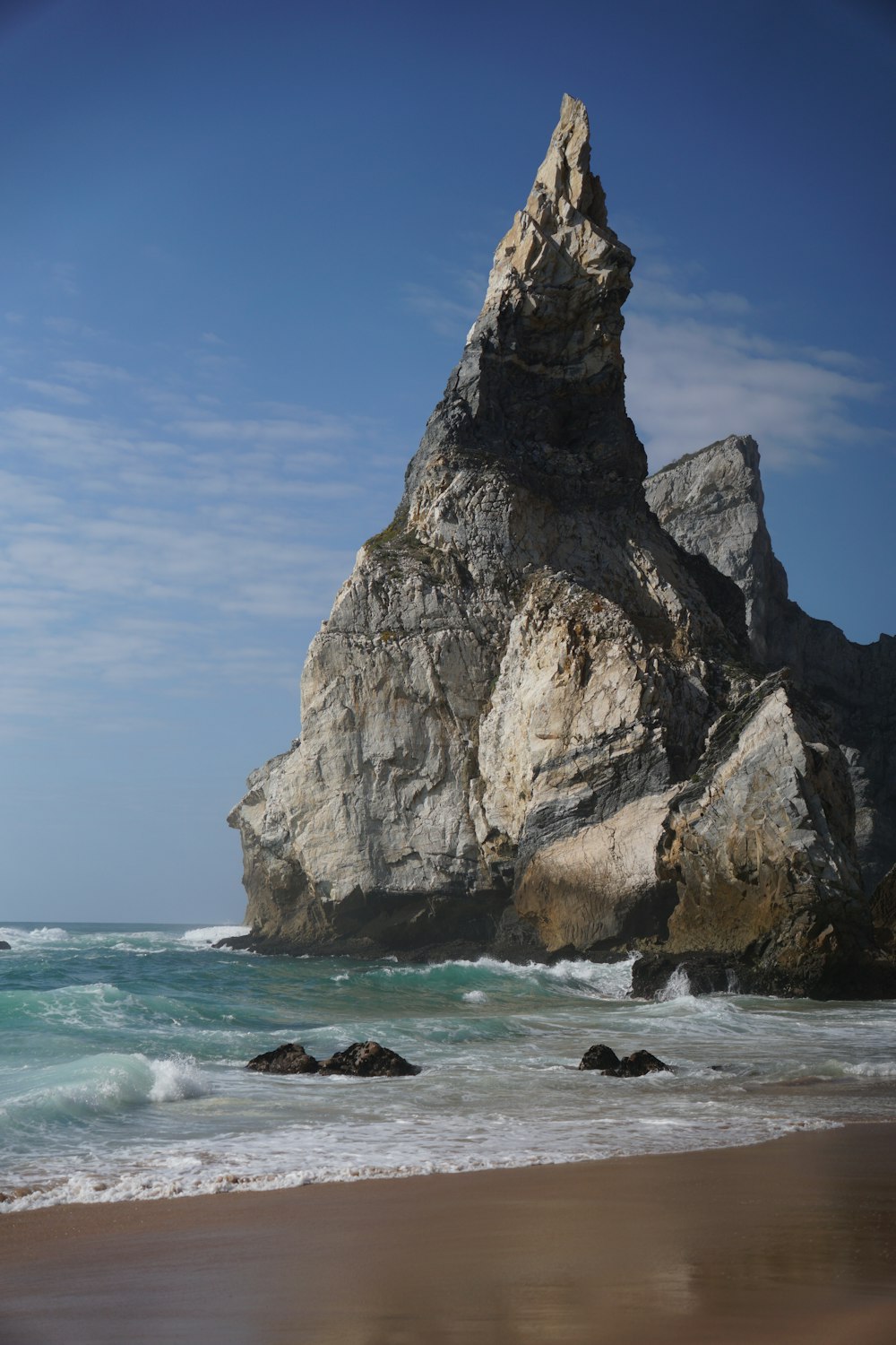 a large rock formation on a beach