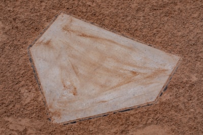 Close-up of a laser-engraved wooden home plate with softball details.