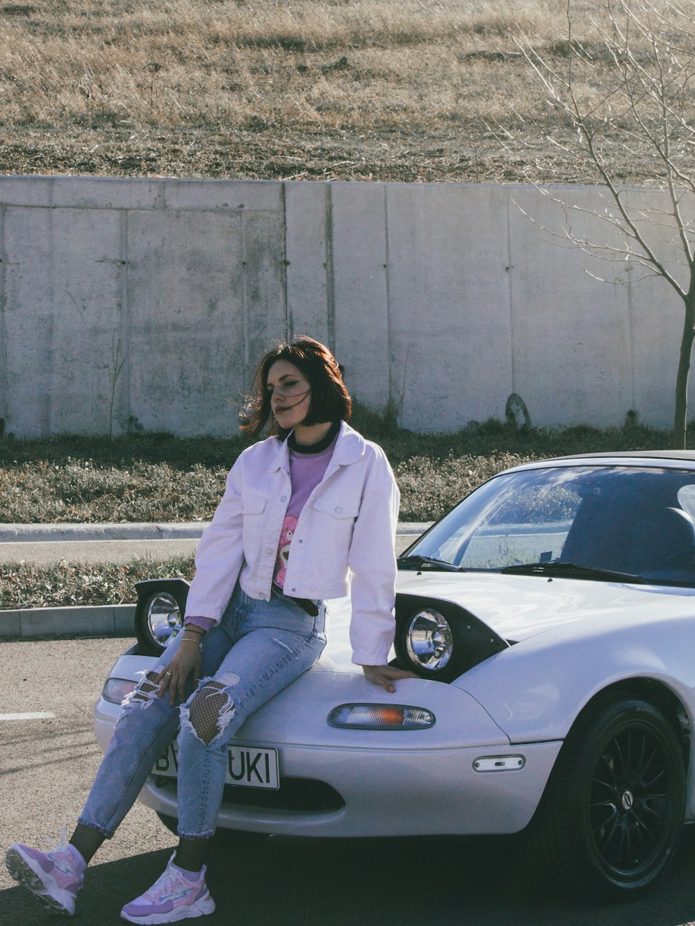 a woman sitting on a car