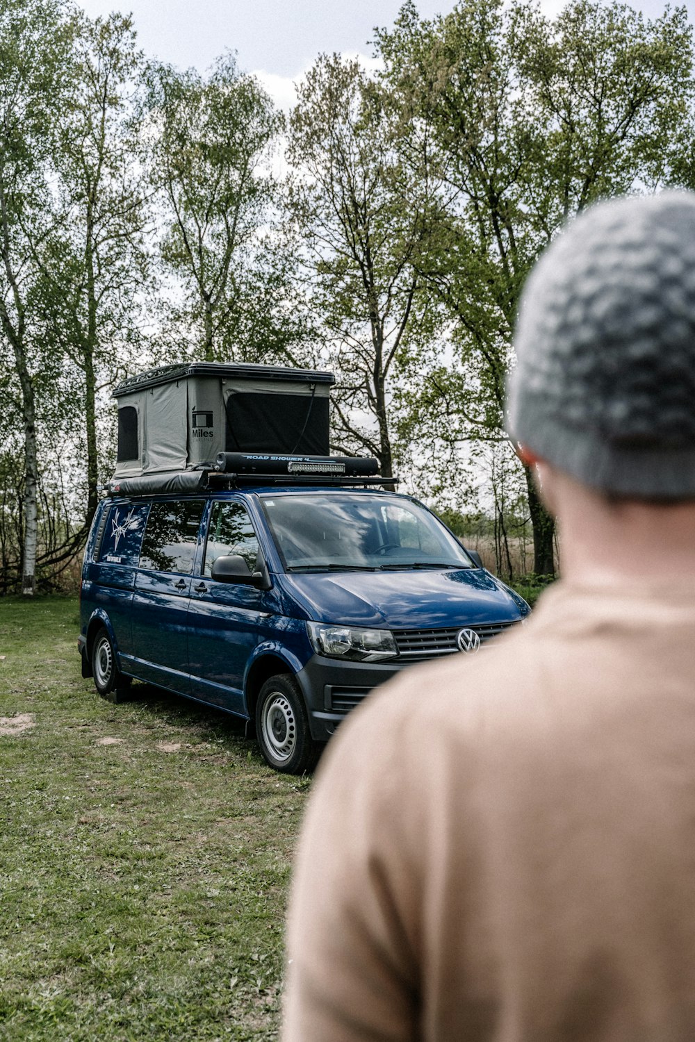 a man looking at a car