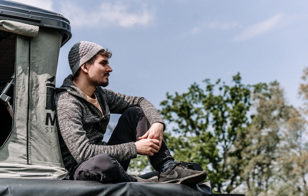 a man sitting on a vehicle