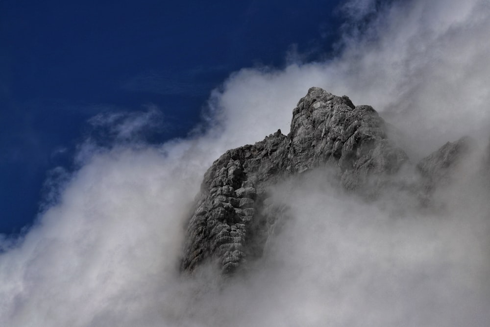 a mountain with clouds around it