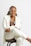 a woman in a white coat