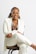 a woman in a white coat