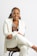 a woman in a white coat