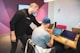 A diverse team collaborating around a laptop in a modern office setting.