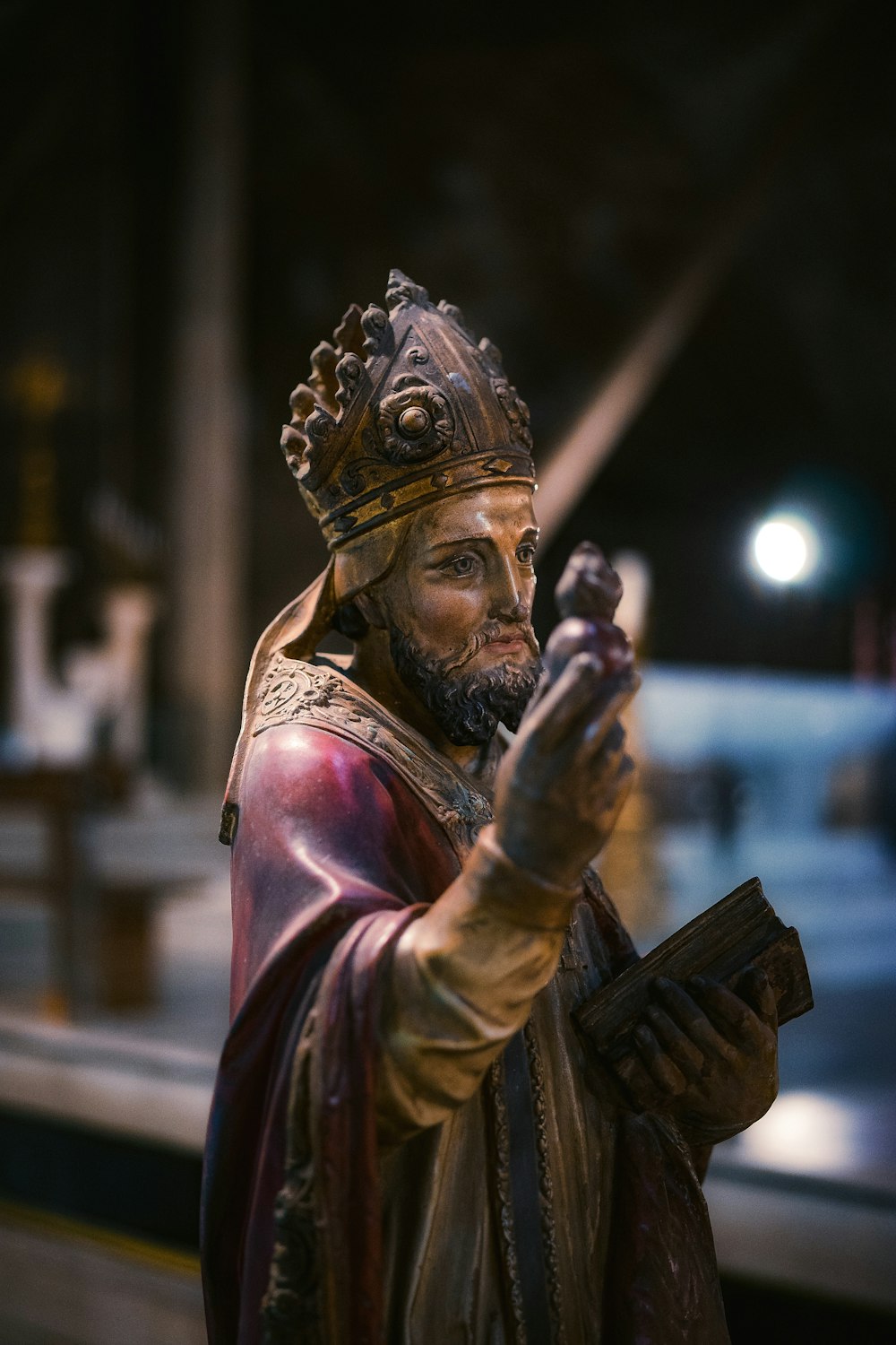 a statue of a person wearing a helmet and holding a sword