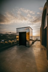 A sleek modern villa bathed in warm sunset light, highlighting its architectural details.