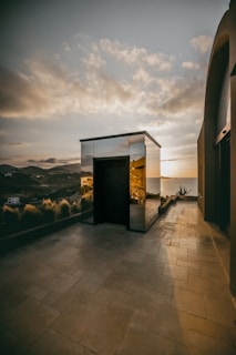 A stunning beachfront villa in Turkey with modern architecture and panoramic sea views at sunset.