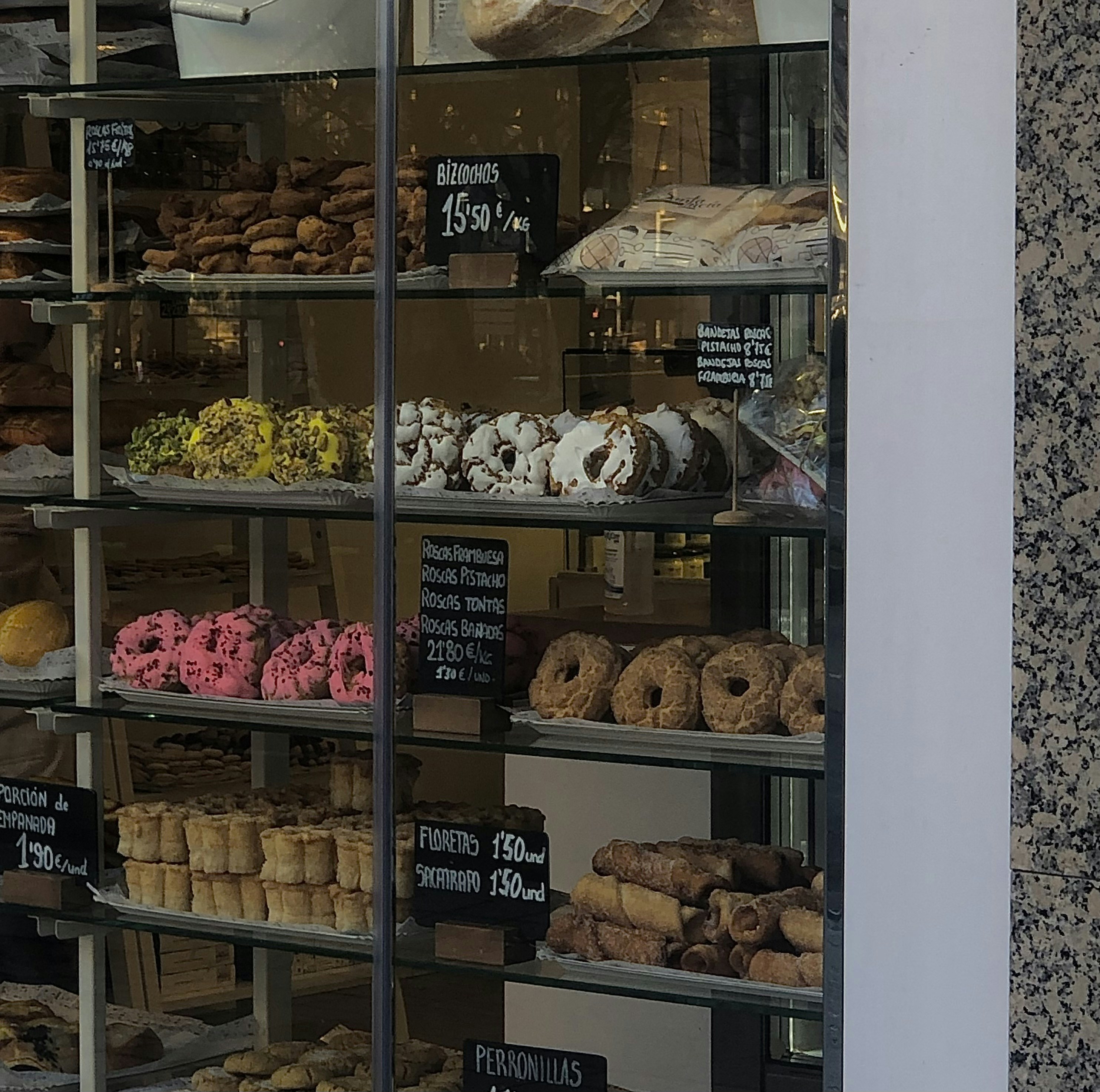 a bakery window with many donuts