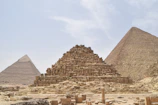 Ancient Nubian pyramids of Meroë standing tall under a bright blue sky.