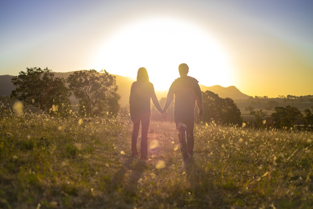 two people standing in a field