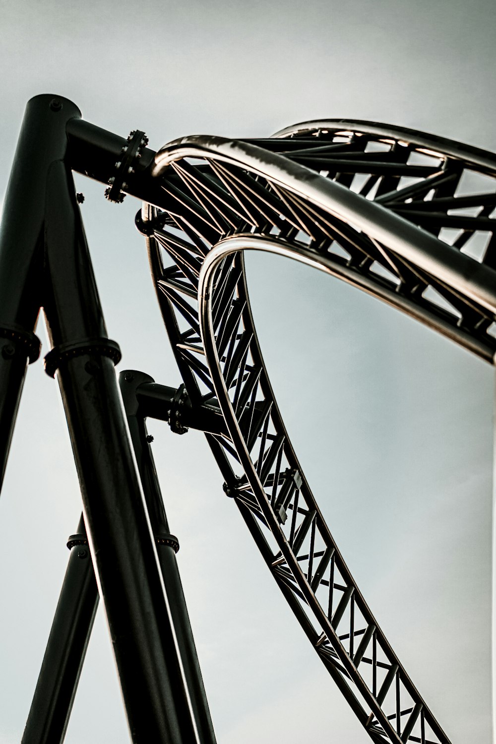 a roller coaster with a cloudy sky