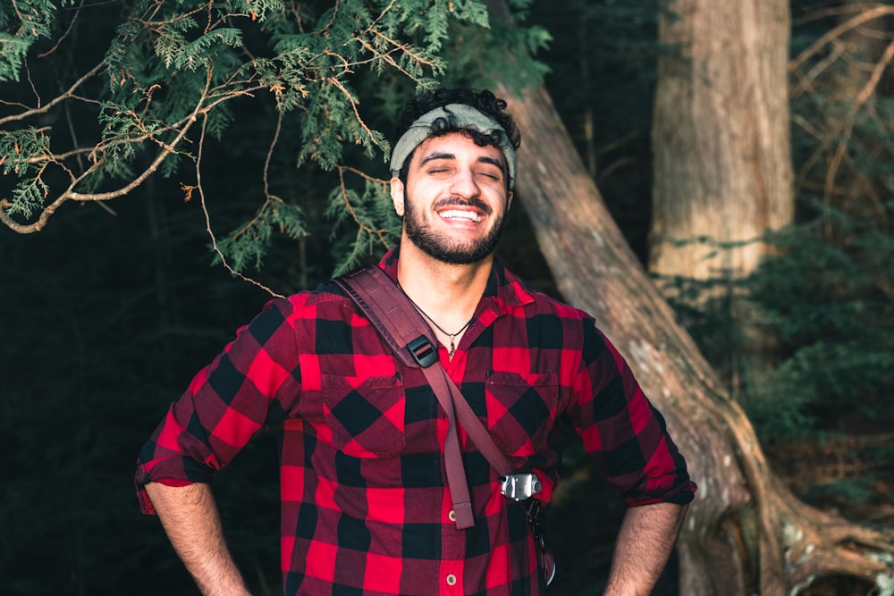 a man wearing a hat and smiling