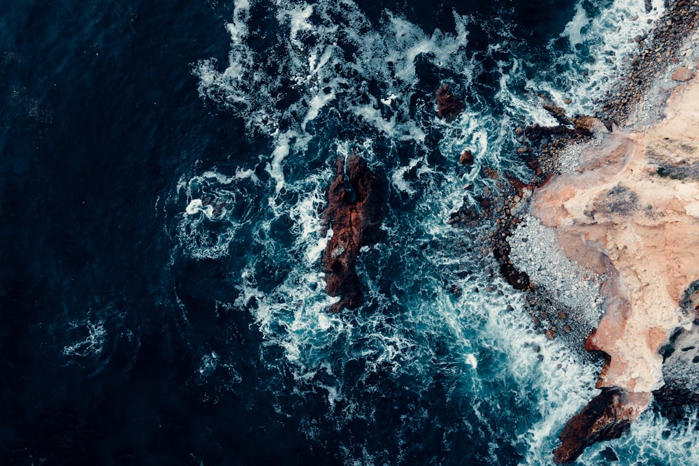 a rocky beach with waves crashing