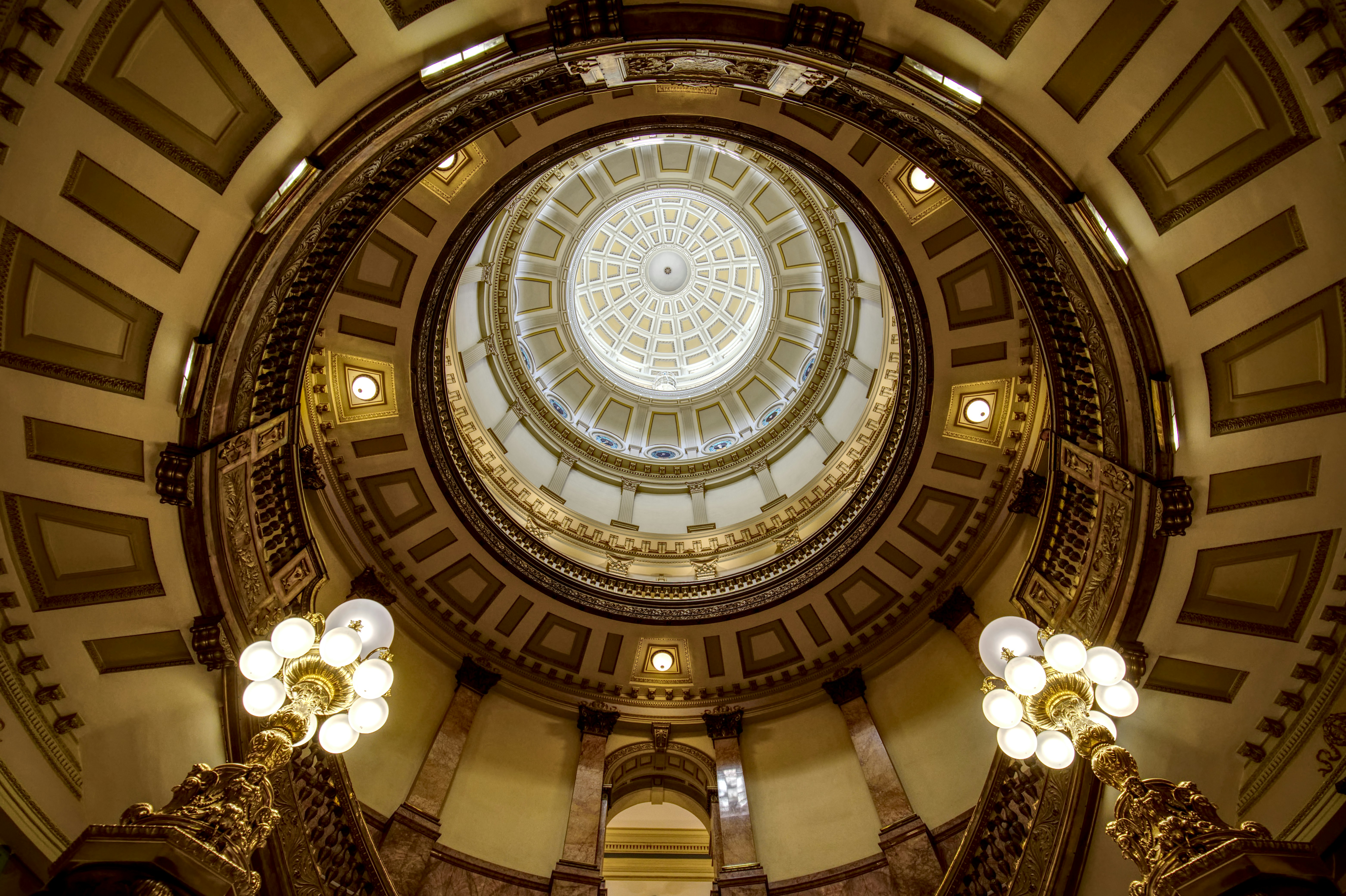 Colorado state capitol building interior first floor of rotunda looking up to dome.