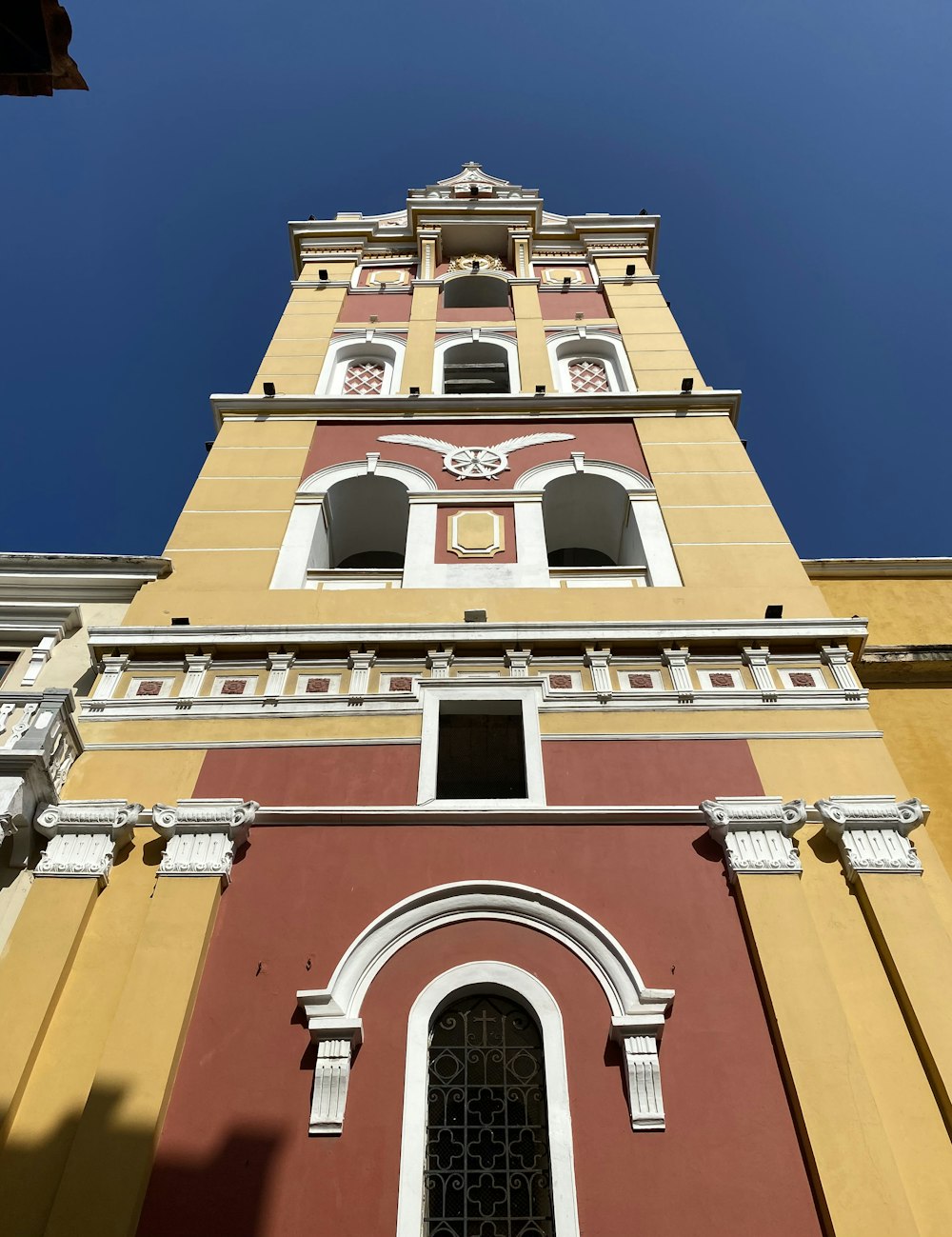 a tall building with a red and yellow exterior