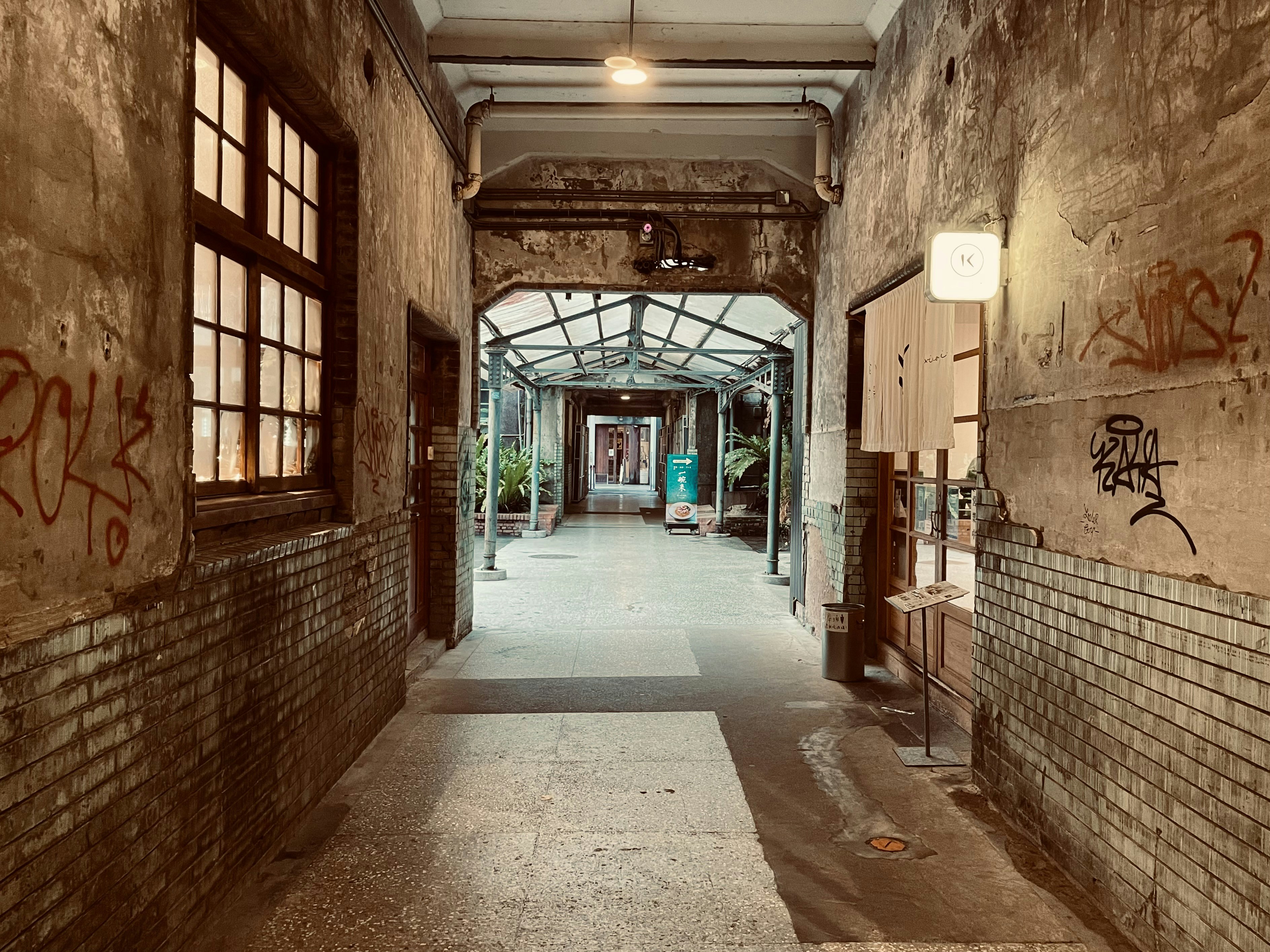 a long hallway with graffiti on the walls