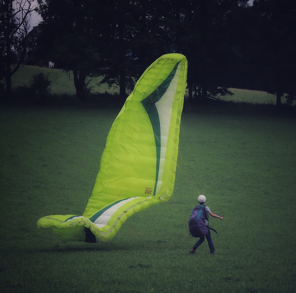 a man walking next to a large yellow fish shaped like a fish