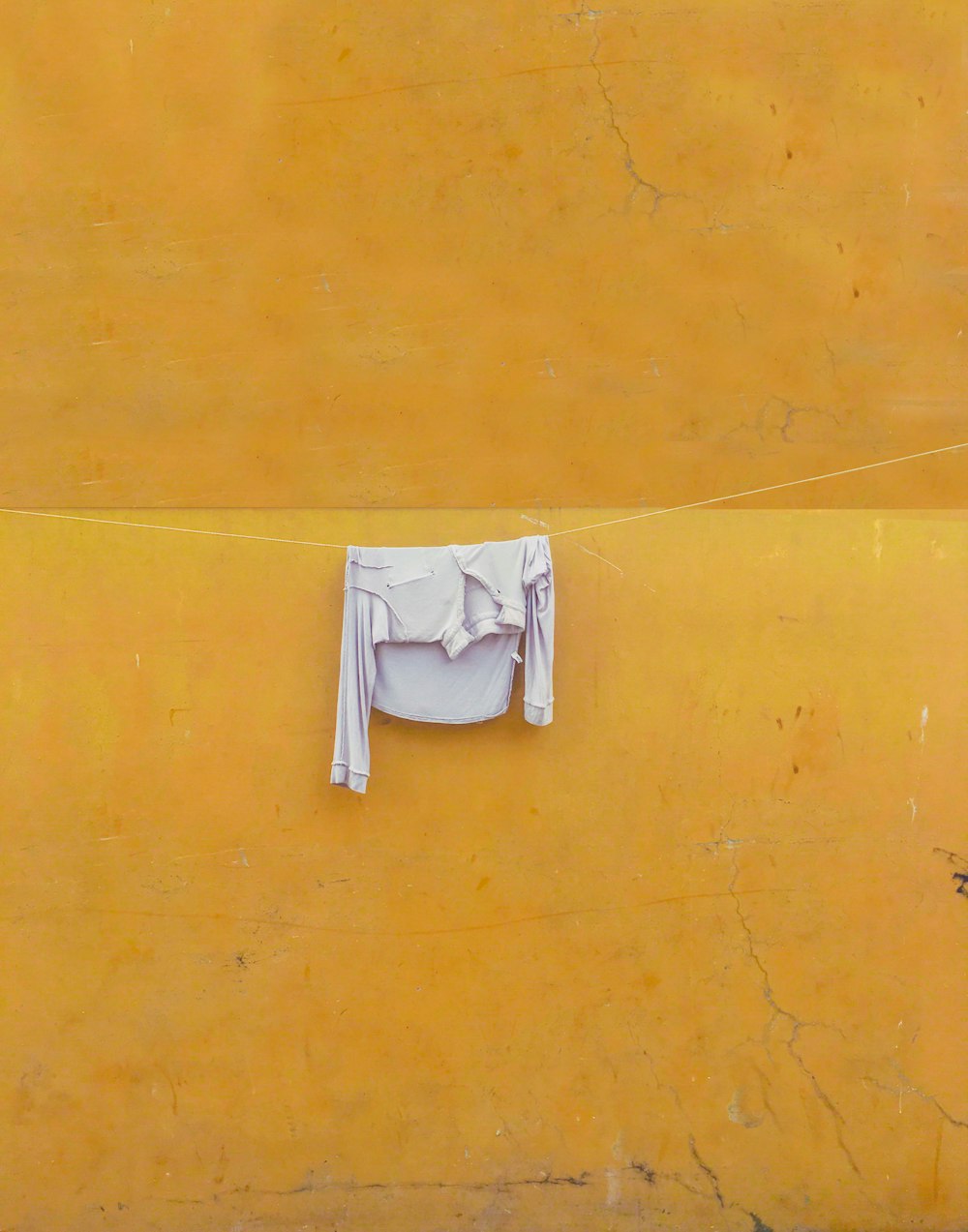 a white towel on a yellow wall