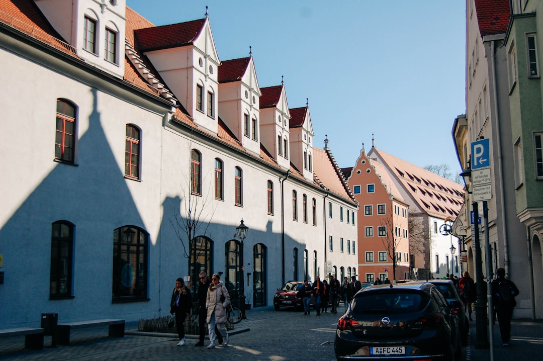 a street with cars and people on it,