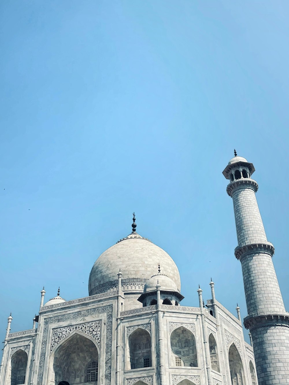 a large white building with a domed roof and towers