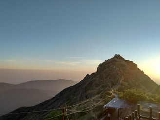 A winding mountain trail under a vibrant sunrise, symbolizing life's challenging journeys.