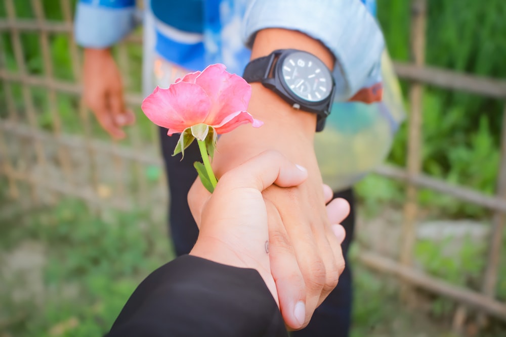 a person holding a flower