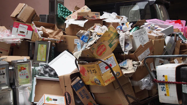 A messy pile of cardboard boxes and assorted items.
