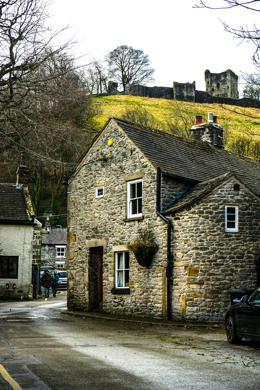 a stone building with a green roof