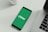 A smartphone displaying the Chime logo on a green background is placed next to a laptop on a white surface.