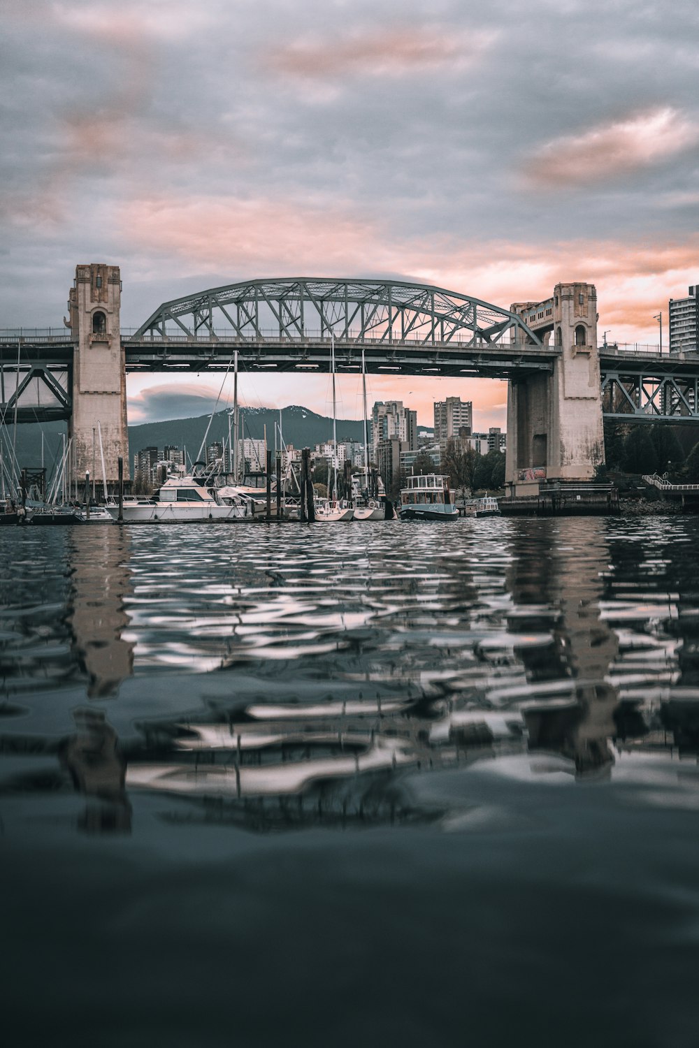 a bridge over water with boats