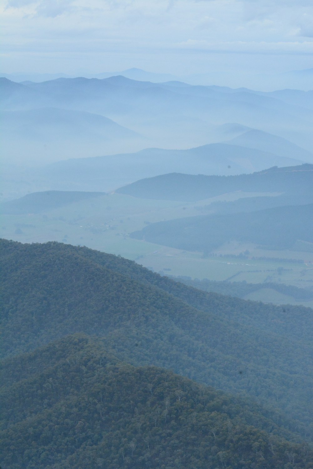 a view of a valley with mountains in the background