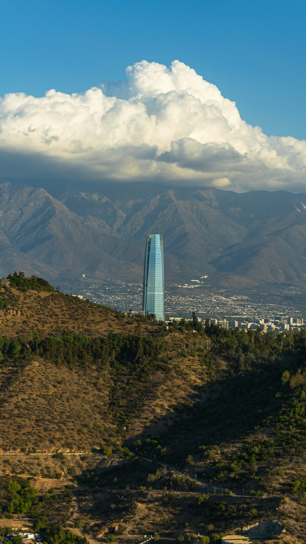 a tall building in the middle of a mountain range