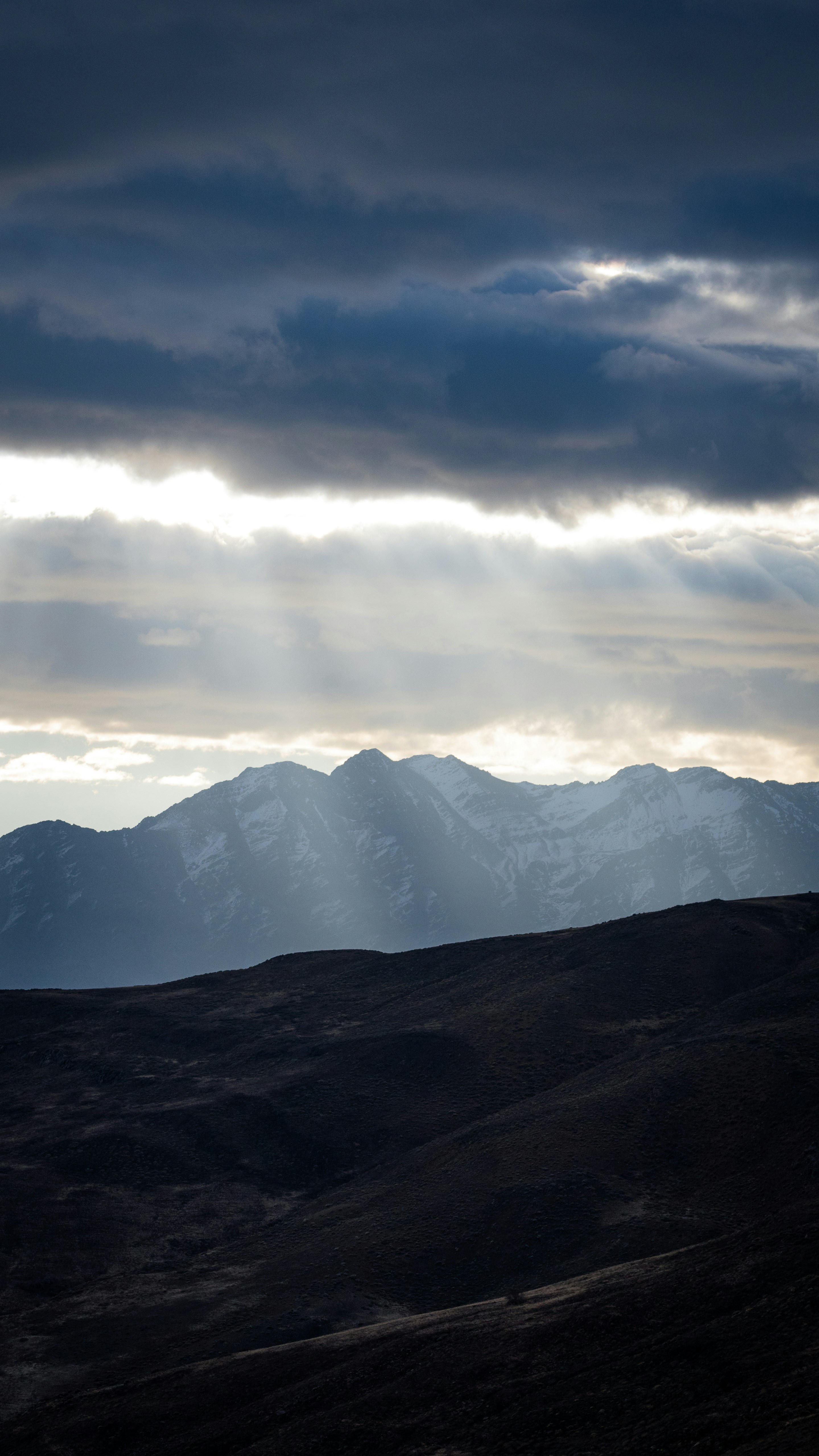 a mountain with clouds above it