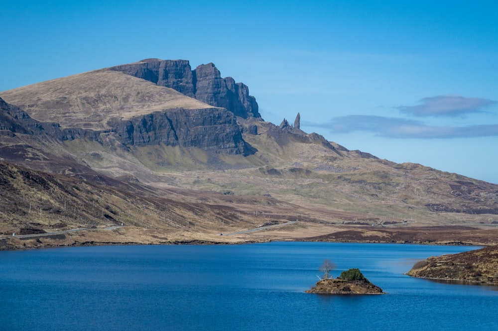 a body of water with a mountain in the background