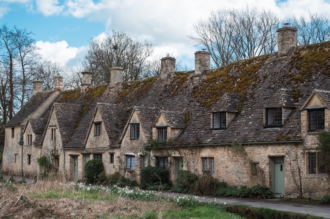 a stone house with a grass yard,
