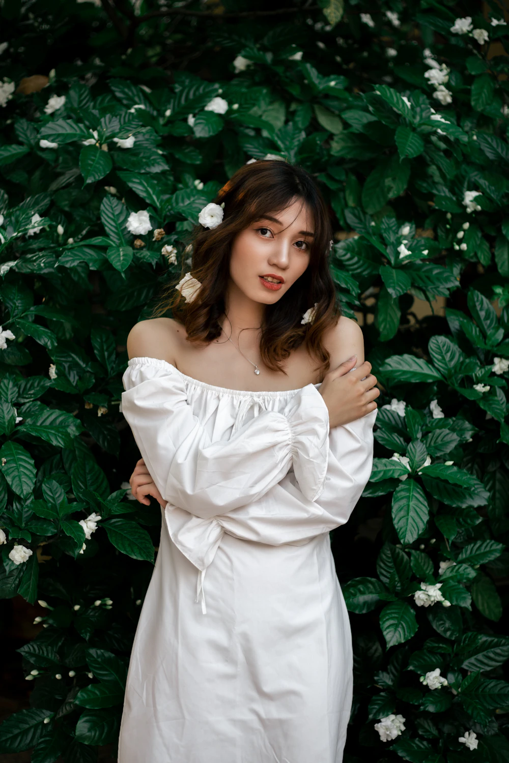 Woman wearing a white puff-sleeve off-shoulder dress