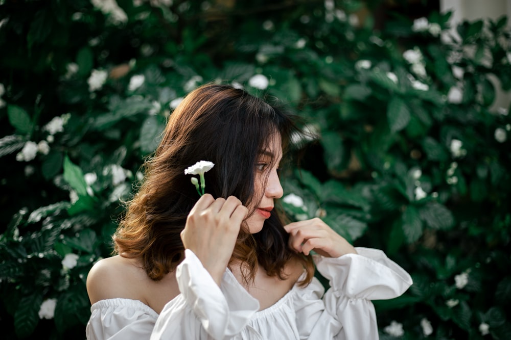 a woman smelling a flower