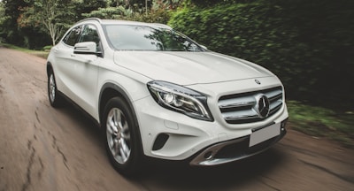 An elegant SUV driving on a picturesque road.