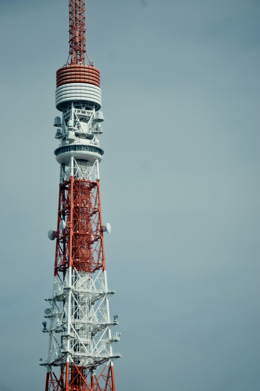 a tall tower with a red and white top