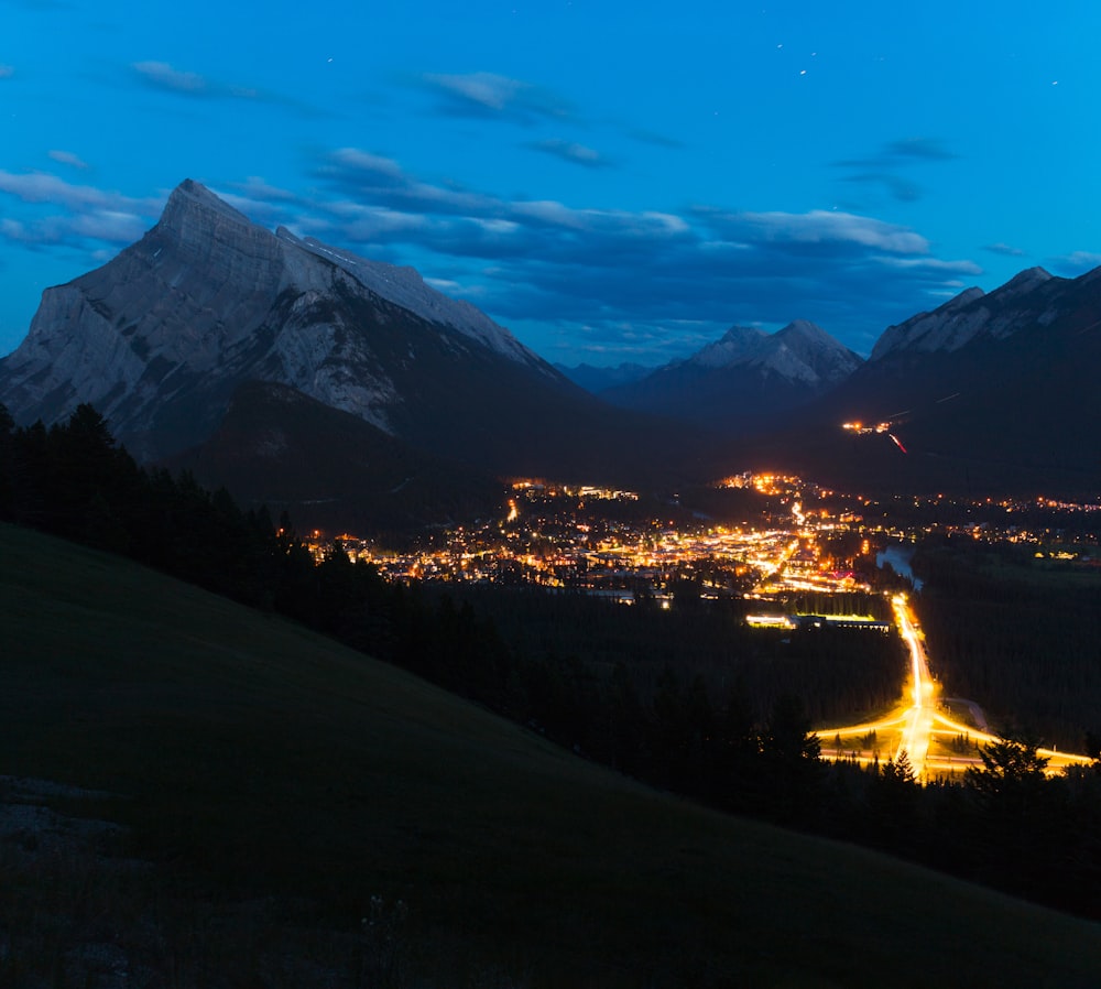 a city with lights in the mountains