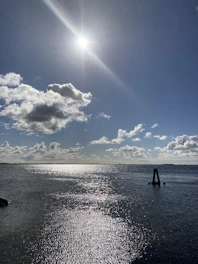 a body of water with a boat in it and a blue sky above
