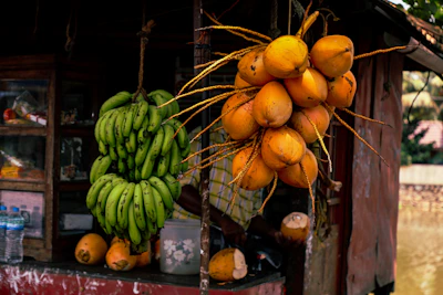 a bunch of bananas and oranges on a table